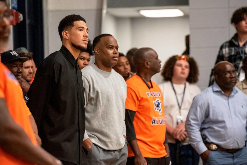 NBA star Devin Booker and his dad during a ceremony for the retirement of Booker’s high school jersey at Moss Point High School in Moss Point on Saturday, Dec. 10, 2022.