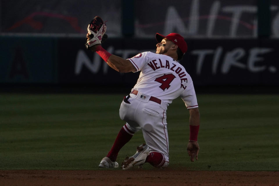 Los Angeles Angels shortstop Andrew Velazquez can't handle a ball hit for an RBI single by New York Mets' Tomas Nido during the second inning of a baseball game Friday, June 10, 2022, in Anaheim, Calif. (AP Photo/Mark J. Terrill)