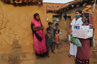 A health worker, right, persuades village woman Maju Kol, left, to get vaccinated against the coronavirus at Jamsoti village, Uttar Pradesh state, India, on June 8, 2021. India's vaccination efforts are being undermined by widespread hesitancy and fear of the jabs, fueled by misinformation and mistrust. That's especially true in rural India, where two-thirds of the country’s nearly 1.4 billion people live. (AP Photo/Rajesh Kumar Singh)