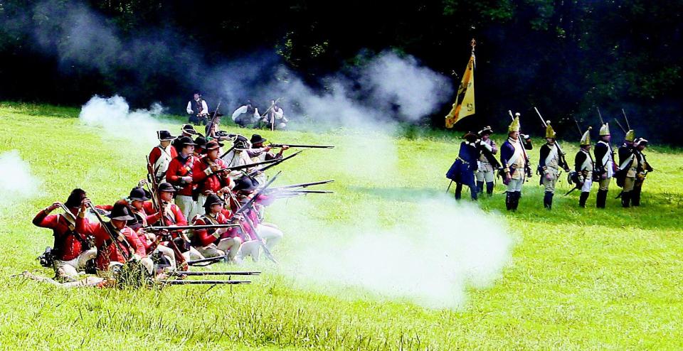 The British battalion returns fire during a past reenactment of the Battle of Cooch's Bridge.
