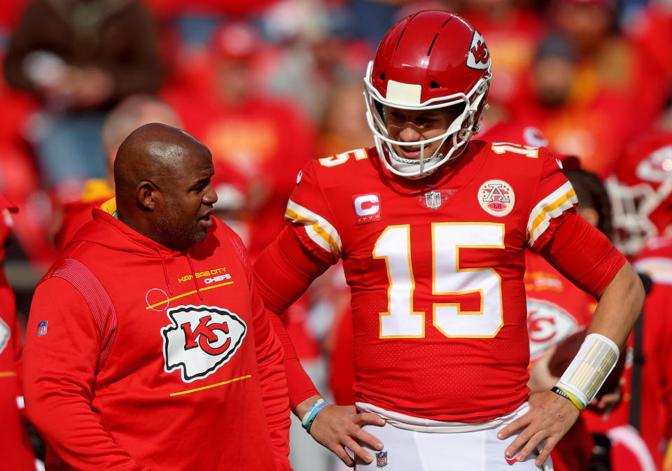 Patrick Mahomes #15 of the Kansas City Chiefs talks with offensive coordinator Eric Bieniemy.