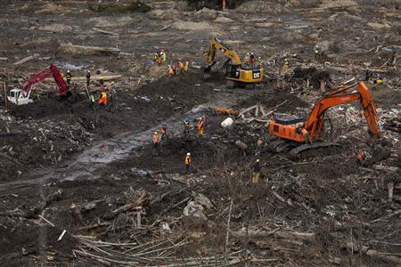 Rescue workers continue to search for human remains in a debris field left by a mudslide in Oso, Washington, April 3, 2014. REUTERS/Max Whittaker