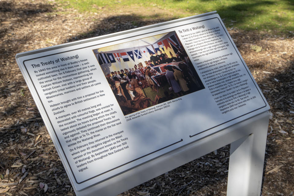 A sign on the Waitangi Treaty Grounds where the Treaty of Waitangi was first signed between Maori and the British Crown on Feb. 6, 1840, detailing the history, is seen in Waitangi, northern New Zealand on Oct. 5, 2020. The debate in New Zealand over becoming a republic has an unusual twist: Many Indigenous Maori support New Zealand sticking with the monarchy, unlike the Indigenous people in many other former British colonies. That's because Maori signed a treaty with the British Crown in 1840 that guarantees them certain rights, and some Maori fear a constitutional change could threaten those rights. (AP Photo/Mark Baker)