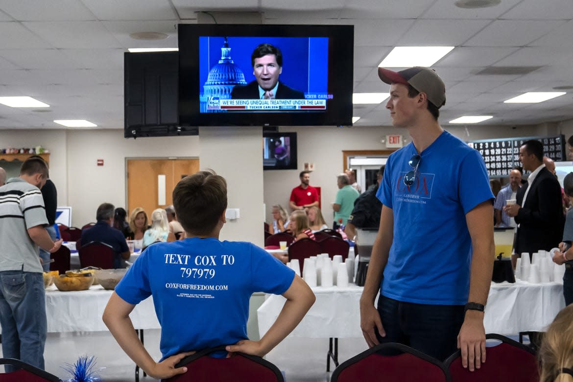 <div class="inline-image__caption"><p>Supporters of Dan Cox, a candidate for the Republican gubernatorial nomination, watch Tucker Carlson on July 19 in Emmitsburg, Maryland.</p></div> <div class="inline-image__credit">Nathan Howard/Getty</div>