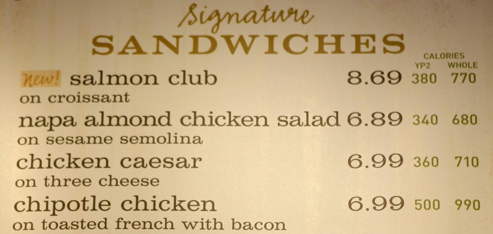 FILE - This march 8, 2010 file photo shows the sandwich board at a Panera store with the calorie count for each item, in Brookline, Mass. Diners could soon see calorie counts on menus of chain restaurants. But what about the roasted chicken sold at grocery stores, or the hot dogs convenience stores sell? Will movie theaters have to tell patrons the number of calories in a giant soda and bucket of popcorn? The food industry is closely watching the Food and Drug Administration to see which establishments are included in the final menu labeling rules, expected this year. (AP Photo/Charles Krupa, File)