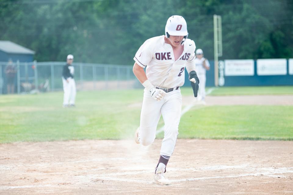 Okemos junior Caleb Bonemer crosses home plate during a regional playoff game against Lakeview at DeWitt High School on Wednesday, June 7, 2023.