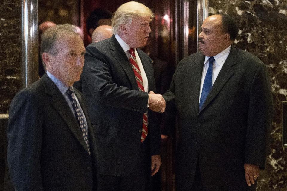 President-elect Donald Trump shakes hands with Martin Luther King III, son of Martin Luther King Jr. at Trump Tower in New York, Monday, Jan. 16, 2017. Also pictured is William Wachtel, left. (AP Photo/Andrew Harnik)