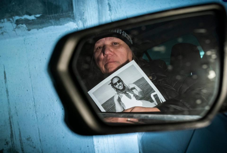 Lorrie Kemp, 58, of Oscoda, holds a photo of her son, Armani Kelly, one of three rappers that went missing on Jan. 21. There three were supposed to perform at a Detroit club, but the event was canceled. Their bodies were later found buried under debris in the basement of an abandoned Highland Park apartment building.