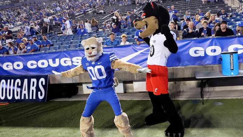 Cosmo and Bearcat interact before the Brigham Young Cougars play the Cincinnati Bearcats at LaVell Edwards Stadium in Provo on Friday, Sept. 29, 2023.