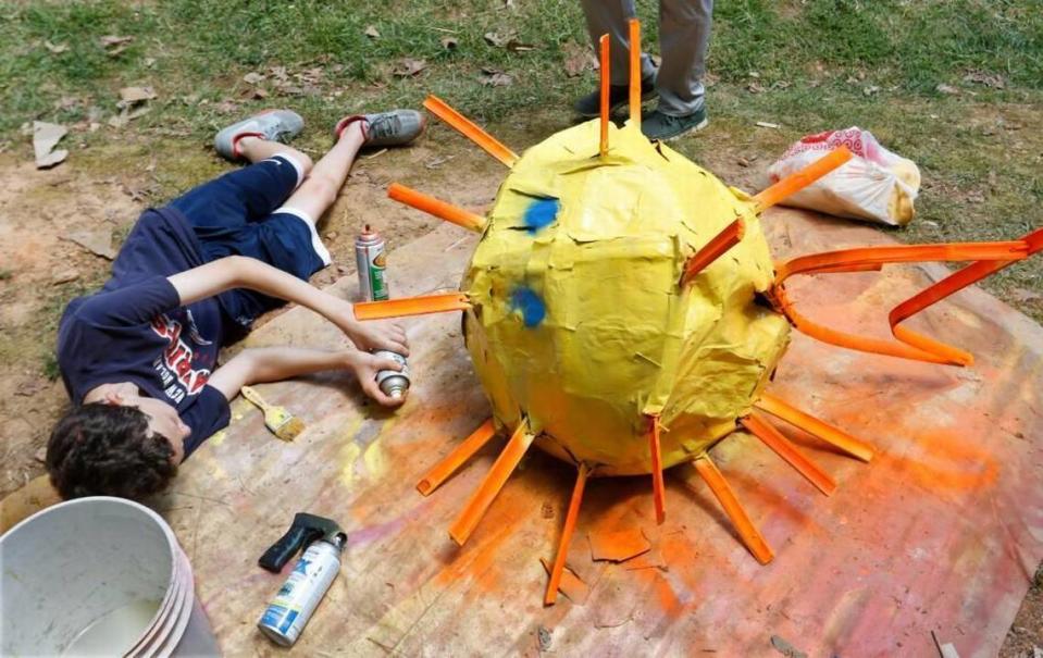 Raleigh’s Magellan Charter School 8th grader Ethan Celata got down and horizontal to spray paint his team’s brightly colored blowfish on April 29, 2016. The State Board of Education voted Thursday, Feb. 2, 2017, to renew 29 North Carolina charter schools, including giving a 10-year extension to Magellan.