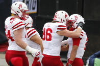 Nebraska quarterback Adrian Martinez, right, celebrates a touchdown against Ohio State with teammates during the first half of an NCAA college football game Saturday, Oct. 24, 2020, in Columbus, Ohio. (AP Photo/Jay LaPrete)