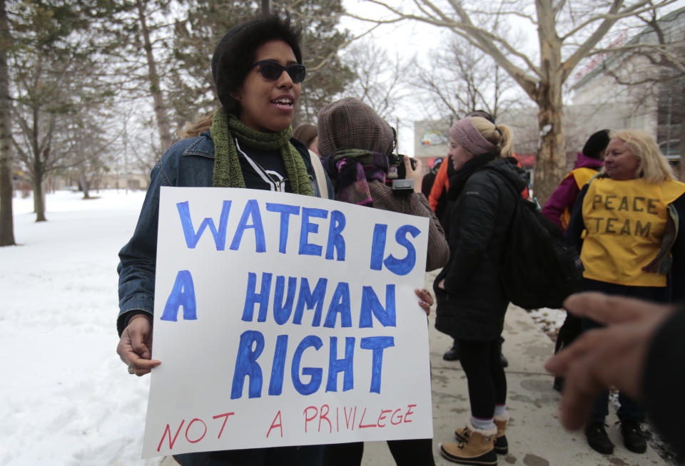 Demonstrators protest over the Flint, Michigan contaminated water crisis outside of the venue where the Democratic U.S. presidential candidates' debate was being held in Flint, Michigan, March 6, 2016. REUTERS/Rebecca Cook