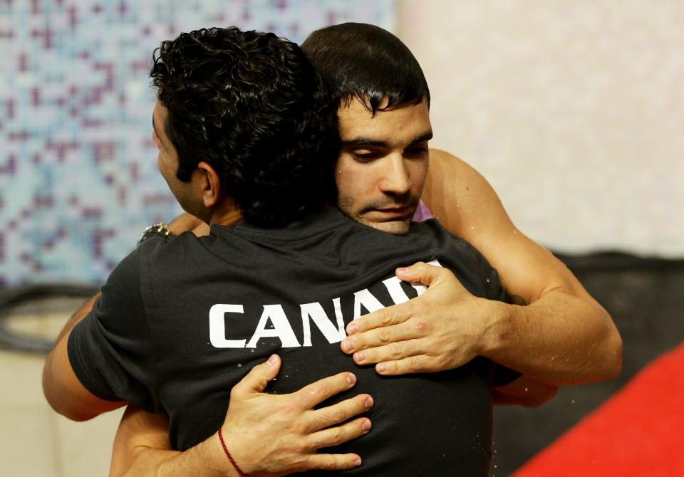 DELHI, INDIA - OCTOBER 11: Alexandre Despatie of Canada celebrates a member of his coaching team after winning the gold medal in the Men's 3m Springboard Final at Dr. S.P. Mukherjee Aquatics Complex during day eight of the Delhi 2010 Commonwealth Games on October 11, 2010 in Delhi, India. (Photo by Matt King/Getty Images)