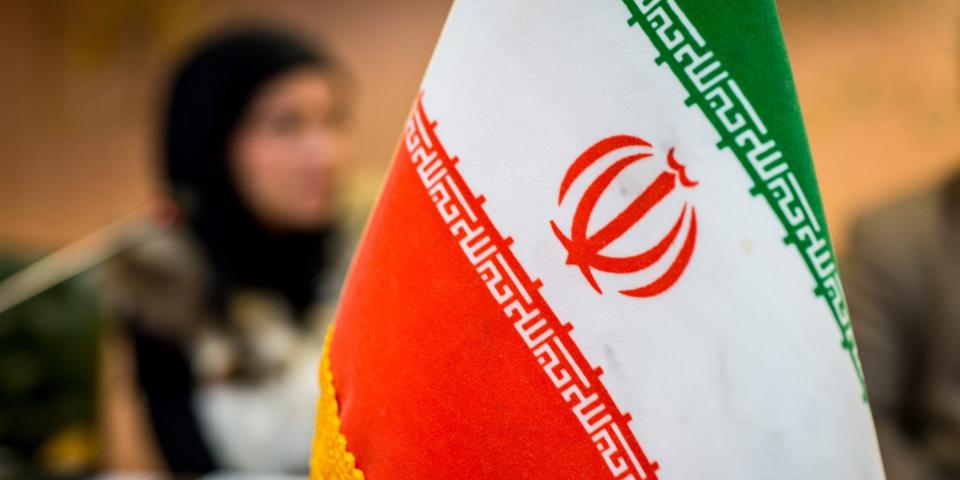 Iranian flag on conference table.