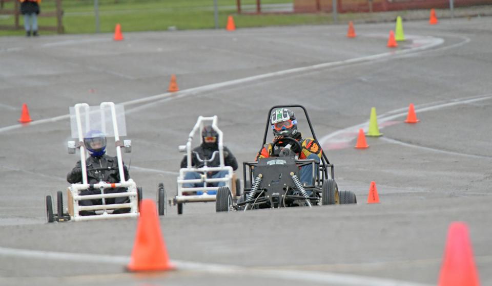 Competitors navigate the course set up in a parking lot at Mid-Ohio on Tuesday morning during the NCSC electric vehicle races.