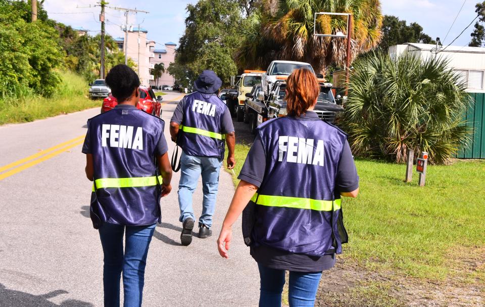 Federal Emergency Management Agency Disaster Survivor Assistance Team members canvass neighborhoods off of Newfound Harbor Drive on Merritt Island.