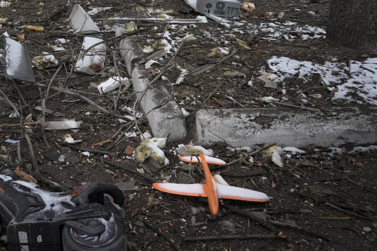 A toy plane lies on the ground amongst debris of a destroyed accommodation building near a checkpoint in Brovary, outside Kyiv, Ukraine, Tuesday, March 1, 2022.