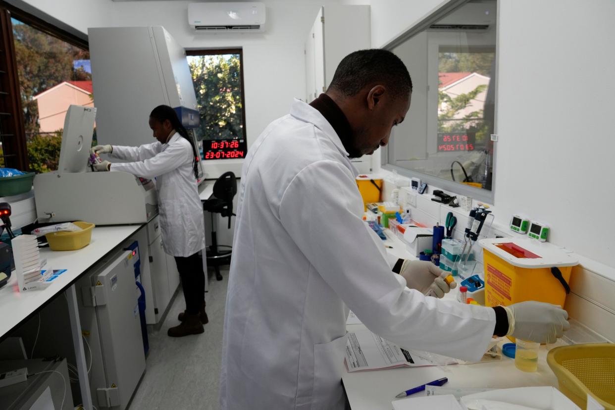 Lab technician Xolile Mhlanga works with vials of lenacapavir at the Desmond Tutu Health Foundation's Masiphumelele Research Site, in Cape Town, South Africa