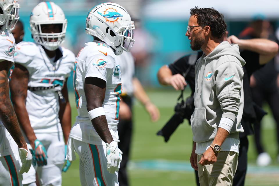 Sep 8, 2024; Miami Gardens, Florida, USA; \Miami Dolphins head coach Mike McDaniel talks with Miami Dolphins wide receiver Tyreek Hill (10) during pregame warm-ups at Hard Rock Stadium. Mandatory Credit: Jim Rassol-Imagn Images