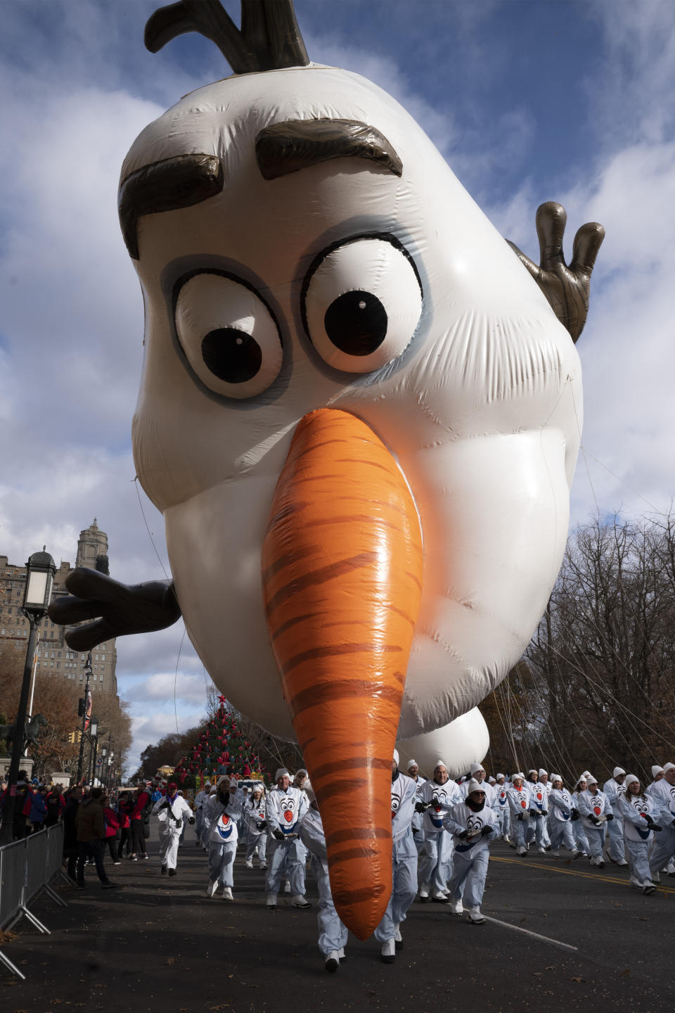 Balloon handlers hold the Olaf balloon as his nose dips toward the ground as strong winds affect the Macy's Thanksgiving Day Parade, Thursday, Nov. 28, 2019, in New York. (AP Photo/Mark Lennihan)