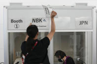 Interpreters work at the main press center during the 2020 Summer Olympics, Friday, July 30, 2021, in Tokyo, Japan. Unlike previous Olympics, all the interpretation is being done remotely with most interpreters working in booths at the main center. Their simultaneous translation can be accessed at all Olympic venues on an app. This eliminates interpreters getting tied up in traffic heading to an venue. (AP Photo/Luca Bruno)