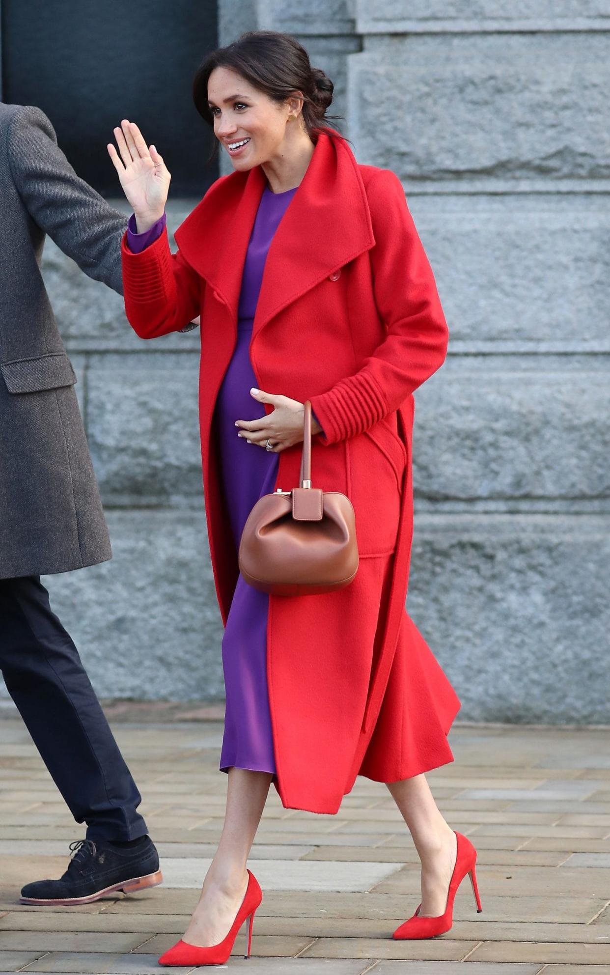 The Duchess of Sussex, wearing unashamedly bold hues of red and purple, on 14th January - GC Images