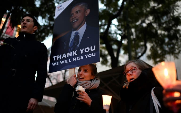 Americans residing in Portugal sing their national anthem as they take part in a vigil at Largo do Carmo in Lisbon on January 20, 2017