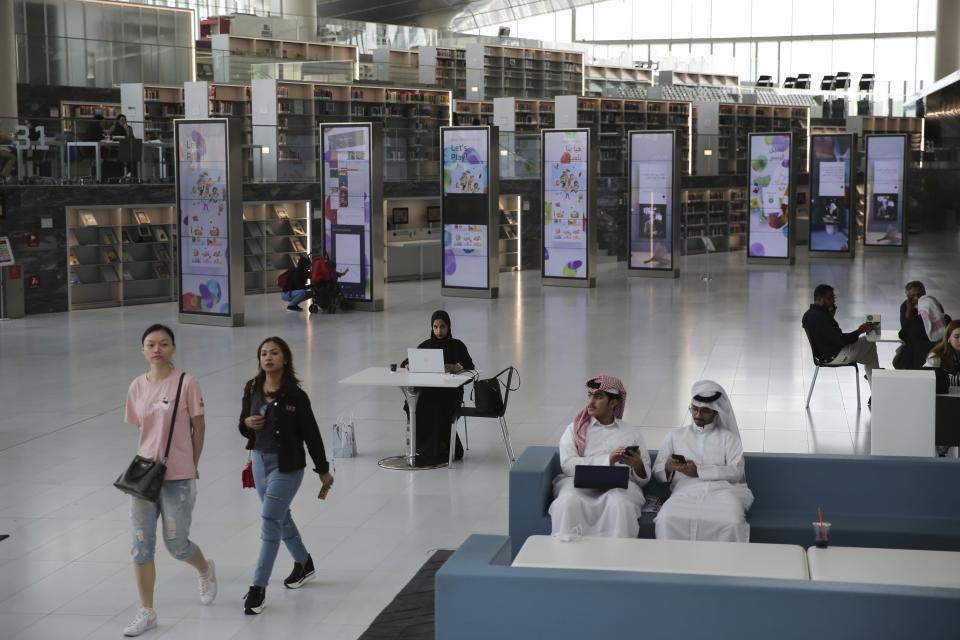 FILE - People study at the Qatar National Library in Doha, Qatar, Tuesday, April 30, 2019. Qatar has sought to portray itself as welcoming foreigners to this hereditarily ruled emirate, where traditional Muslim values remain strong. (AP Photo/Kamran Jebreili, File)