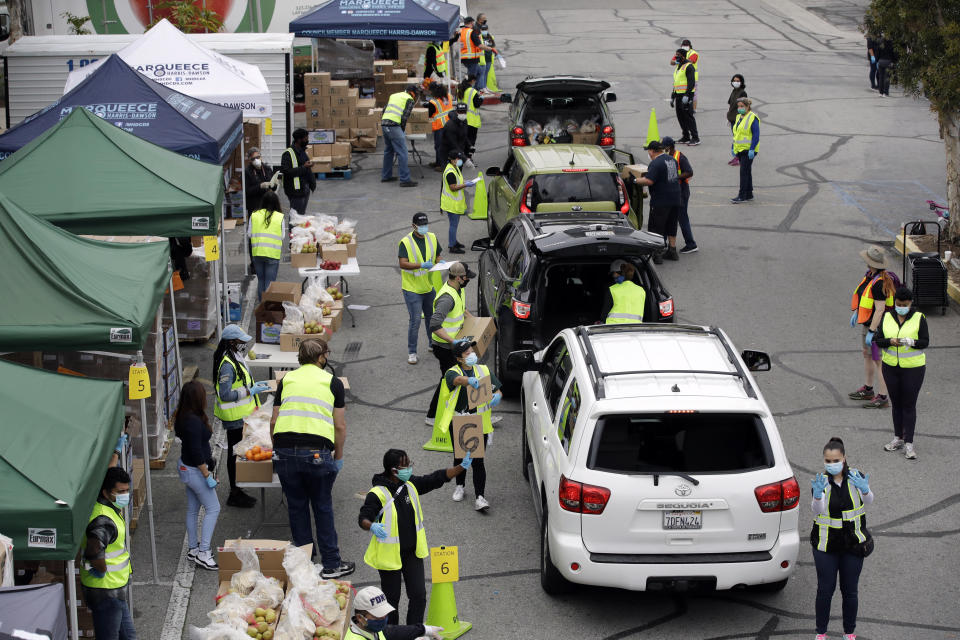 FILE — In this April 7, 2020 file photo food is loaded into vehicles at a food distribution center in the Crenshaw district of Los Angeles. Gov. Gavin Newsom suffered political backlash after it surfaced that he and his wife attended a party Nov. 6, 2020, with a dozen friends at the pricy French Laundry restaurant in wine country north of San Francisco. Newsom is facing the second recall of a governor in California history and the last day to vote is Sept. 14, 2021.AP Photo/Marcio Jose Sanchez,File)