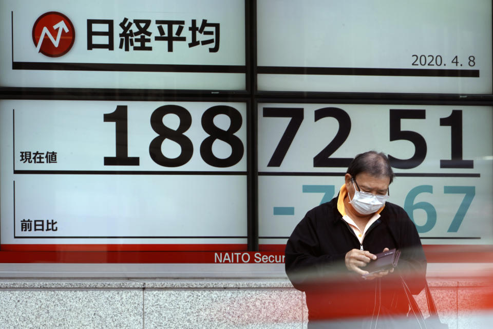 A man stands in front of an electronic stock board showing Japan's Nikkei 225 index at a securities firm Wednesday, April 8, 2020, in Tokyo. Asian shares were mostly lower after gyrating in early trading amid uncertainty over the coronavirus outbreak. Japan’s Nikkei 225 inched up in Wednesday morning trading, but benchmarks in Australia, South Korea and Chine are lower. (AP Photo/Eugene Hoshiko)