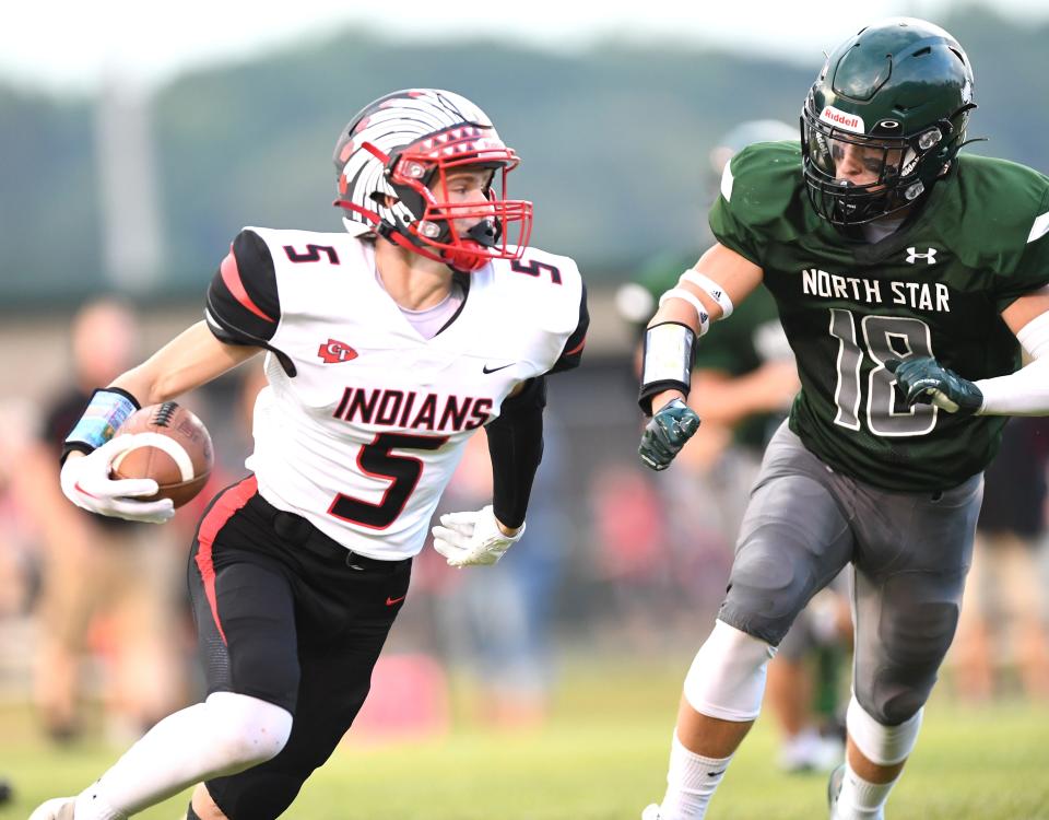 Conemaugh Township's Ethan Black runs free through the secondary before being taken down by North Star's Garrett Tunstall (18) on the first play from scrimmage in the WestPAC football opener for both teams, Aug. 26, in Boswell.