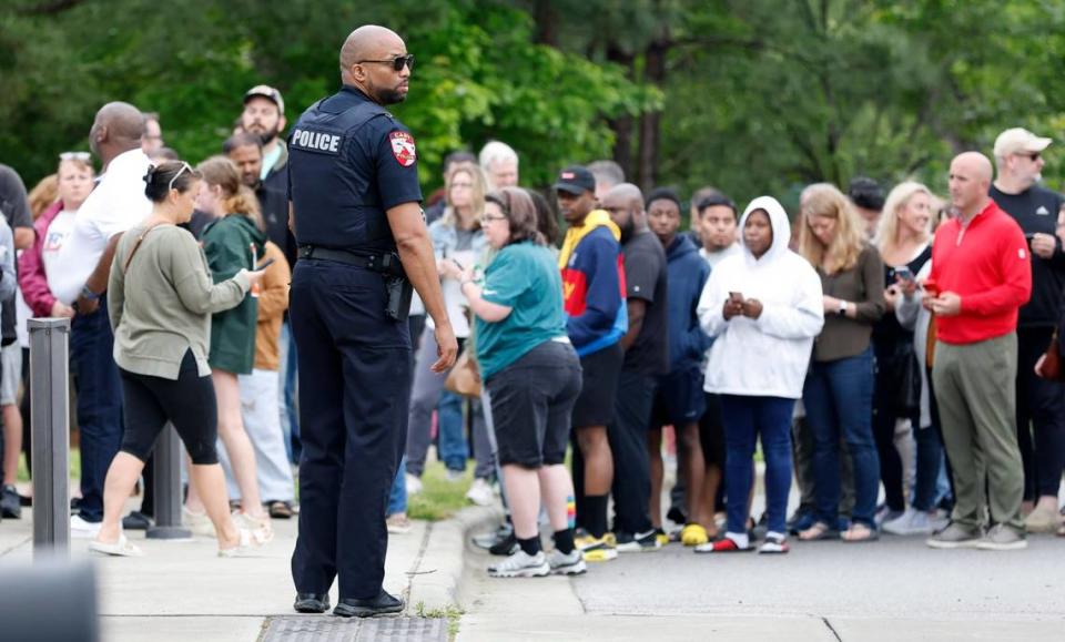 Parents line up at Middle Creek Community Library to check out their children from Middle Creek High School in Apex, N.C., on April 27, 2023 after a gun was reported on campus. New security rules are being proposed for when people visit Wake County school campuses. Ethan Hyman/ehyman@newsobserver.com