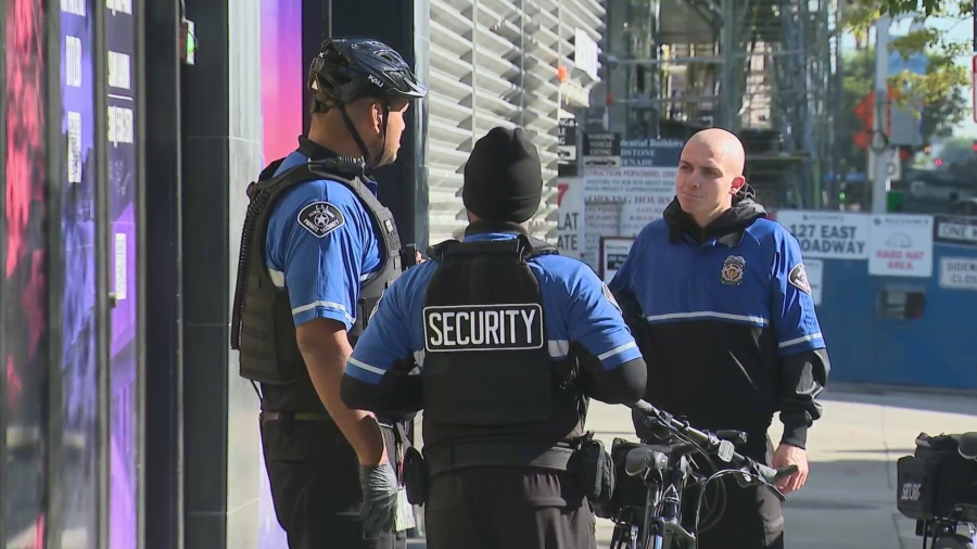 Private security guards are seen in Long Beach.