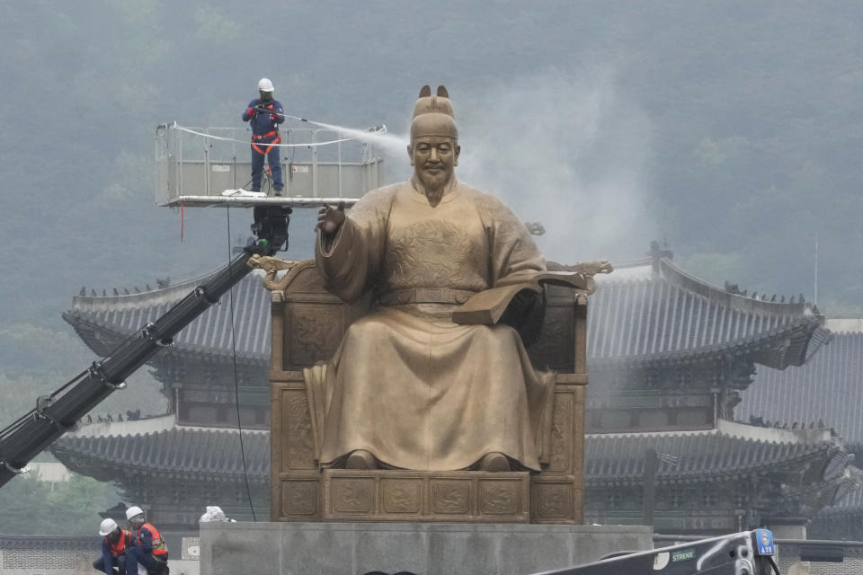 A worker sprays water onto the statue of King Sejong for a spring cleaning at the Gwanghwamun Plaza in Seoul, South Korea, Tuesday, April 16, 2024. King Sejong, the fourth king of the Joseon Dynasty (1392-1910), created the Korean alphabet, Hangul, in 1446. (AP Photo/Ahn Young-joon)