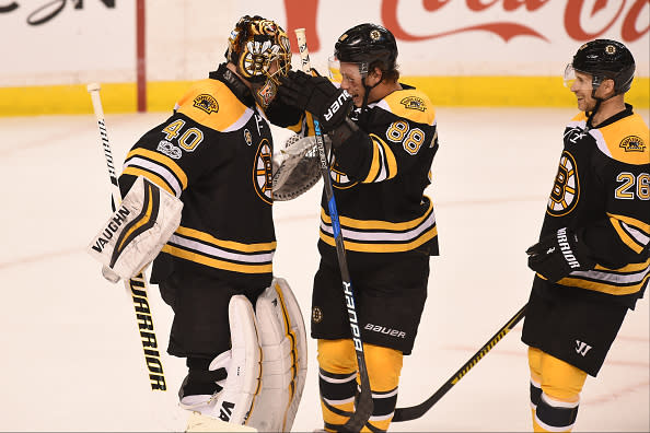 BOSTON, MA - APRIL 4: Tuukka Rask #40, David Pastrnak #88 and John-Michael Liles #26 of the Boston Bruins celebrate a shut out win and a clinched play off spot against the Tampa Bay Lightning at the TD Garden on April 4, 2017 in Boston, Massachusetts. (Photo by Steve Babineau/NHLI via Getty Images)