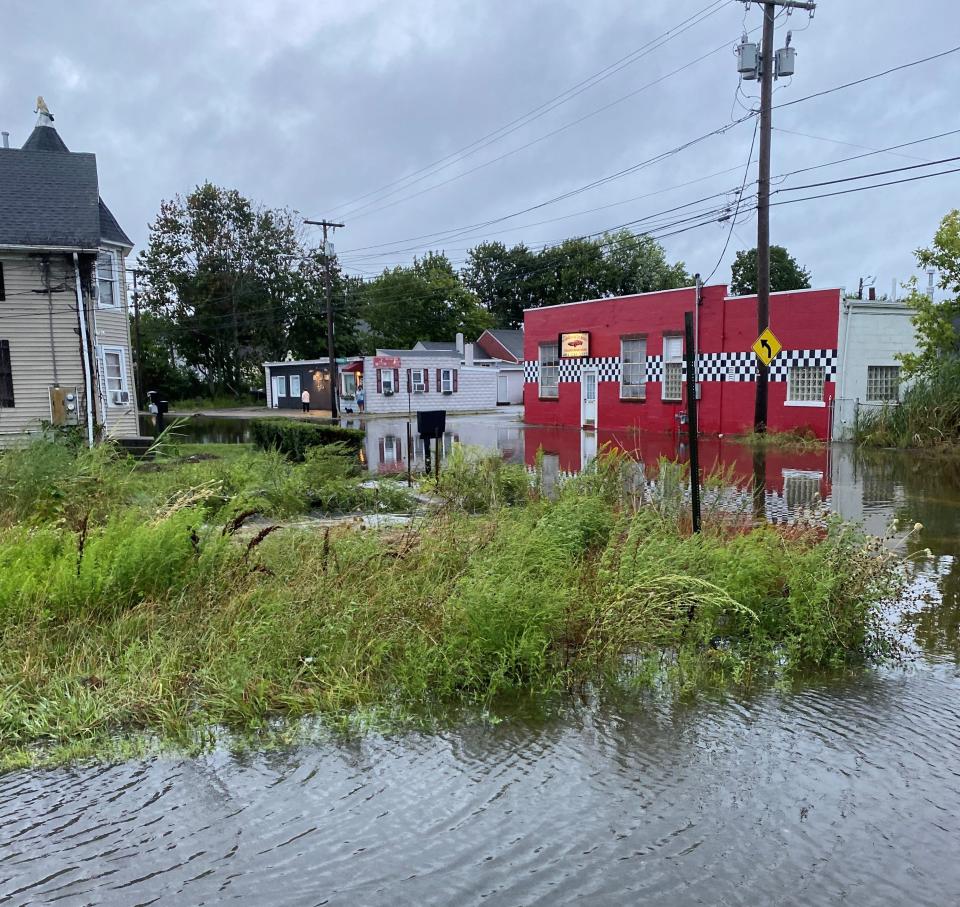 The day after the remnants of Hurricane Ida collided with another weather system and swept through New England in September 2021, unleashing torrential rain over the region, floodwater laps at the foundation of Warren Auto Body, which sits in one of the lowest spots in the Market Street neighborhood.