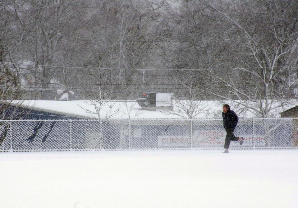 Nathan Perkins of Stoughton refruses to let a nor'easter prevent him from getting his workout in at the Stoughton High School athletic track on Tuesday, Feb. 13, 2024.