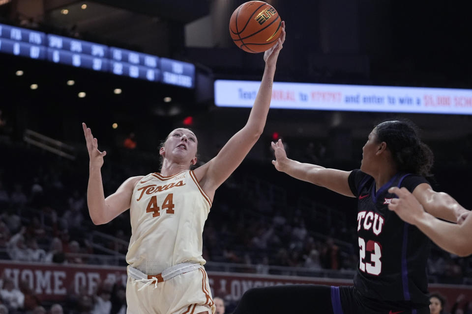 Texas forward Taylor Jones (44) grabs a rebound next to TCU forward Aaliyah Roberson (23) during the second half of an NCAA college basketball game in Austin, Texas, Wednesday, Jan. 10, 2024. (AP Photo/Eric Gay)