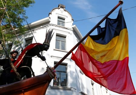 "The Savage", a white performer in a blackface disguise, parades during the festival Ducasse d'Ath in Ath