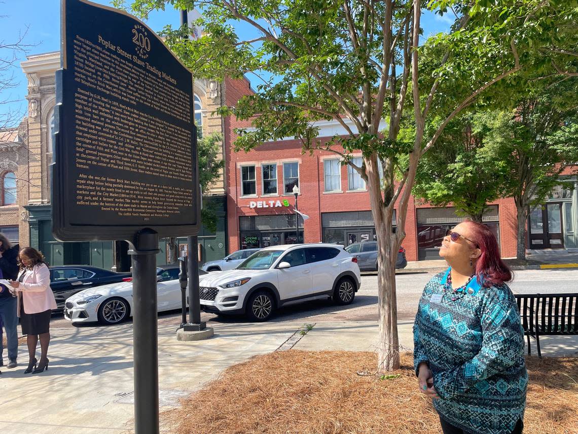 Muriel McDowell-Jackson, head genealogical and historical librarian at Washington Memorial Library, admires a new marker that was unveiled in downtown Monday. Jackson authored the markers which are dedicated to Black history in Macon.
