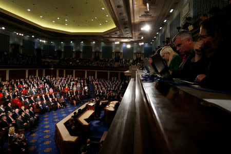 French President Emmanuel Macron addresses a joint meeting of the U.S. Congress as journalists watch from the press gallery in the House chamber of the U.S. Capitol in Washington, U.S., April 25, 2018. REUTERS/Jonathan Ernst