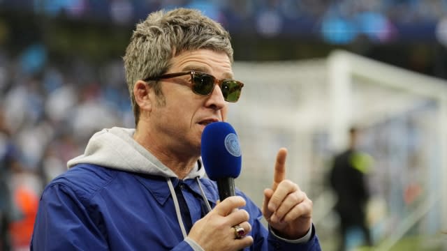Manchester musician Noel Gallagher speaks on the pitch before the Champions League semifinal.