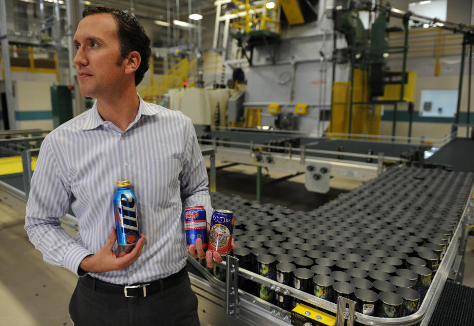 Dan Vorlage, of Ball Corporation, holds cans, Tuesday Oct. 11, 2011, at Ball Corporation in Westminster that are part of the new aluminum can look for the company. RJ Sangosti, The Denver Post  (Photo By RJ Sangosti/The Denver Post via Getty Images)