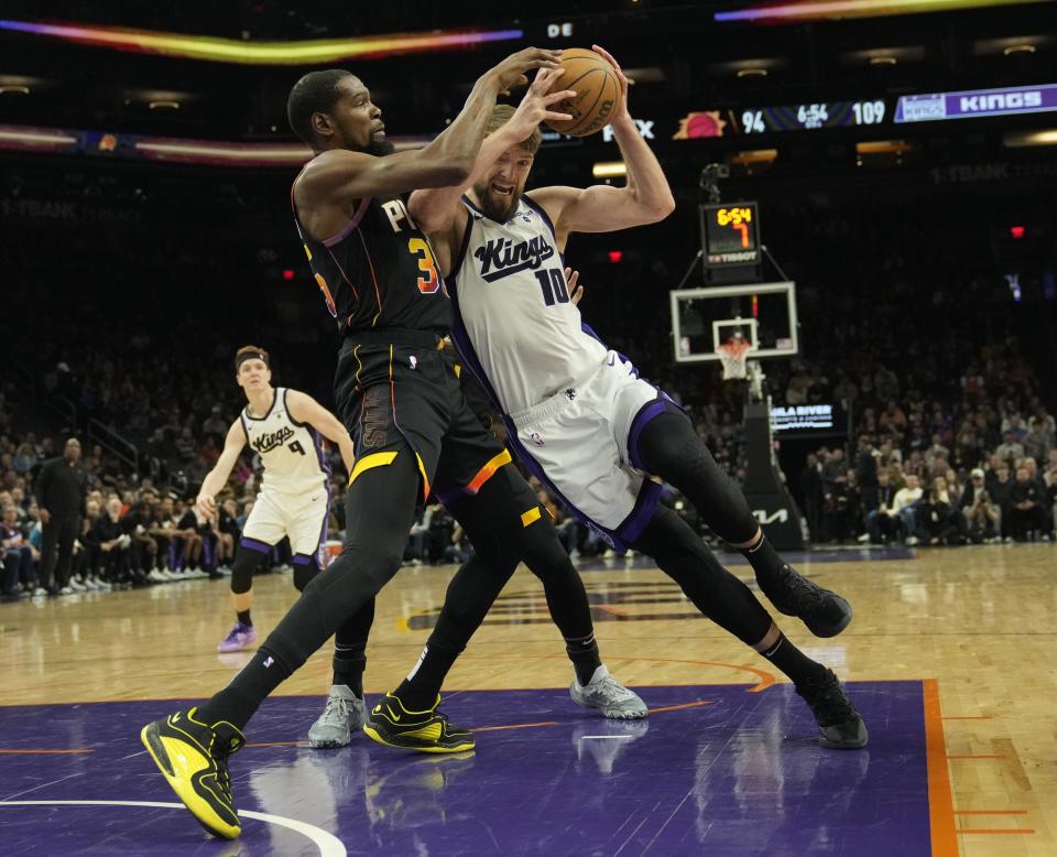 Phoenix Suns forward Kevin Durant (35) defends Sacramento Kings forward Domantas Sabonis (10) during the fourth quarter at Footprint Center in Phoenix on Jan. 16, 2024.