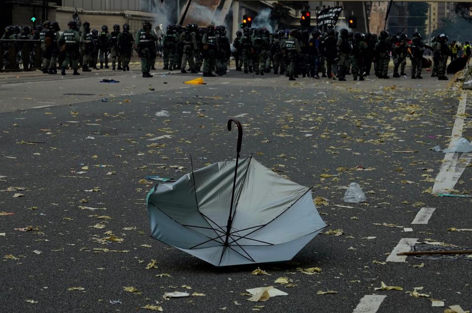 An anti-government protester's umbrella lies on the ground after a clash with police in Hong Kong, Tuesday, Oct. 1, 2019. Thousands of black-clad protesters marched in central Hong Kong as part of multiple pro-democracy rallies Tuesday urging China's Communist Party to "return power to the people" as the party celebrated its 70th year of rule. (AP Photo/Vincent Yu)