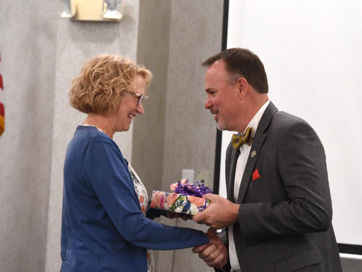 Dr. Eric Bond, superintendent of Augusta County Public Schools, presents a gift to Stuarts Draft Elementary's Liz Benbow, the division's teacher of the year for 2022-23.