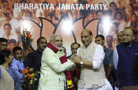 India's Hindu nationalist Narendra Modi (center L) is congratulated by Rajnath Singh (center R), president of India's main opposition Bharatiya Janata Party (BJP), after Modi was crowned as the prime ministerial candidate for the BJP at the party headquarters in New Delhi September 13, 2013. REUTERS/Anindito Mukherjee