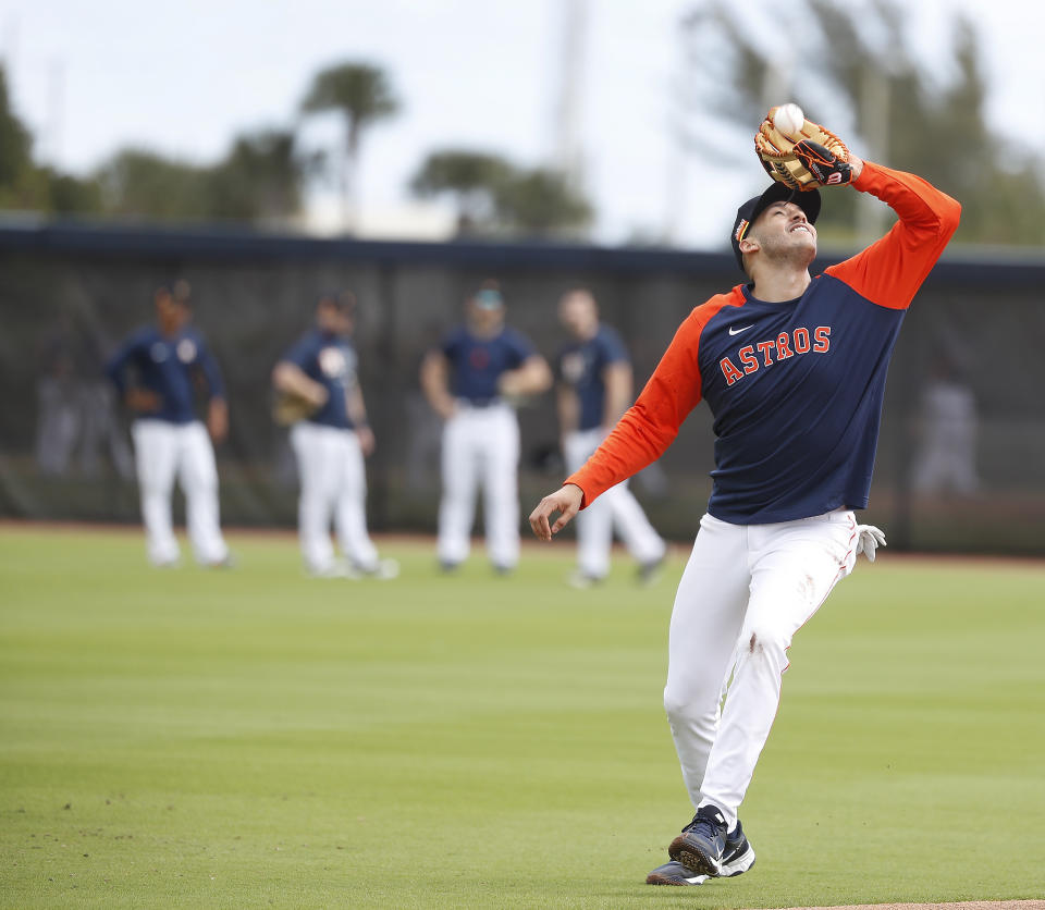 Houston Astros shortstop Carlos Correa catches a pop out during spring training baseball in West Palm Beach, Fla., Monday, Feb. 22, 2021. (Karen Warren/Houston Chronicle via AP)