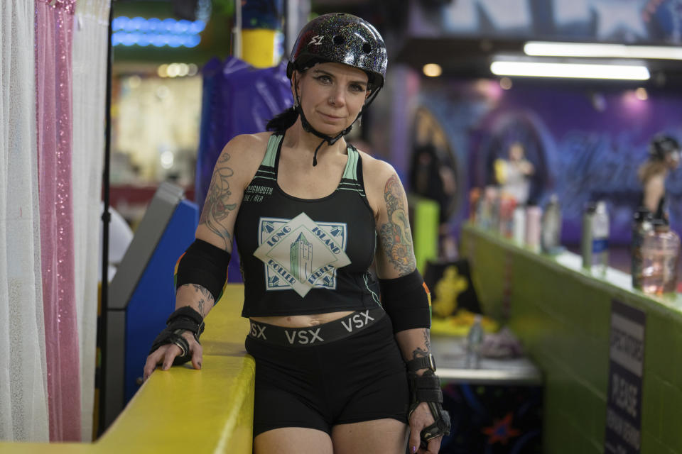 Caitlin Carroll, one of members of the Long Island Roller Rebels, stands for a photograph, Tuesday, March 19, 2023, at United Skates of America in Seaford, N.Y. (AP Photo/Jeenah Moon)