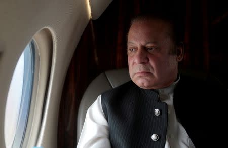 FILE PHOTO: Pakistani Prime Minister Nawaz Sharif looks out the window of his plane after attending a ceremony to inaugurate the M9 motorway between Karachi and Hyderabad, Pakistan February 3, 2017. REUTERS/Caren Firouz/File Photo